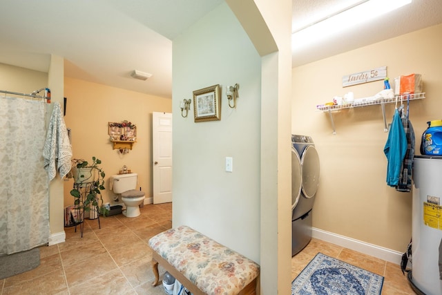 222 Bennie Camp Rd, Dunlap, TN 37327 - laundry room featuring washing machine and dryer, gas water heater, tile patterned floors, baseboards, and arched walkways