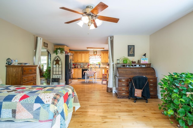 222 Bennie Camp Rd, Dunlap, TN 37327 - bedroom with stainless steel refrigerator with ice dispenser, multiple windows, and light wood-style floors