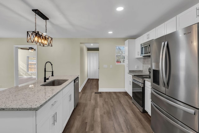 806 Drummond Dr, Nashville, TN 37211 - kitchen featuring stainless steel appliances, a sink, dark wood-type flooring, light stone counters, and white cabinets