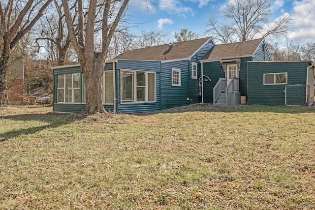 806 Drummond Dr, Nashville, TN 37211 - rear view of house with a sunroom, roof with shingles, and a lawn