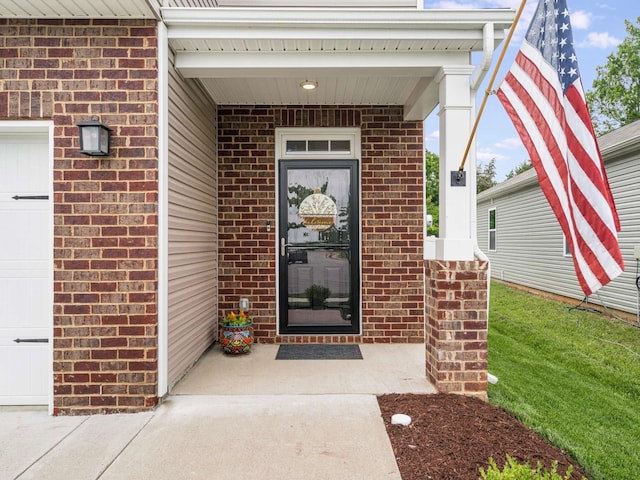 7231 Carrie Ct, Antioch, TN 37013 - doorway to property with brick siding, a porch, and an attached garage