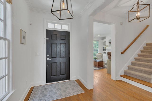 118 Jasper Ave, Franklin, TN 37064 - entrance foyer featuring a chandelier, stairway, wood finished floors, baseboards, and crown molding