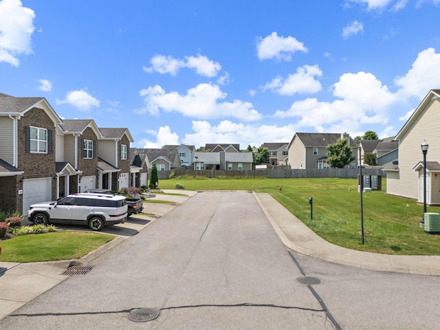 1071 Muna Ct, Spring Hill, TN 37174 - view of asphalt road featuring a residential view, curbs, and street lighting