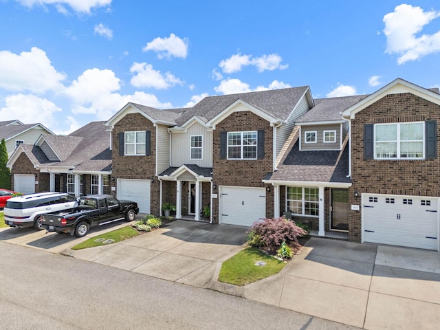 1071 Muna Ct, Spring Hill, TN 37174 - view of front facade featuring driveway, brick siding, a garage, and roof with shingles