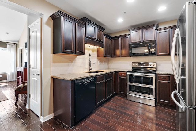 1071 Muna Ct, Spring Hill, TN 37174 - kitchen featuring black appliances, a sink, dark wood-style flooring, dark brown cabinets, and light stone countertops