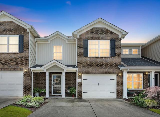 1071 Muna Ct, Spring Hill, TN 37174 - view of front of property featuring driveway, brick siding, board and batten siding, and an attached garage
