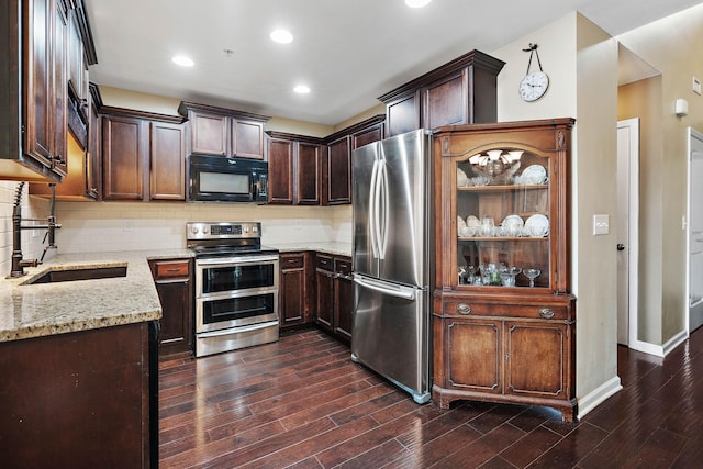 1071 Muna Ct, Spring Hill, TN 37174 - kitchen with stainless steel appliances, a sink, light stone counters, dark wood-type flooring, and decorative backsplash