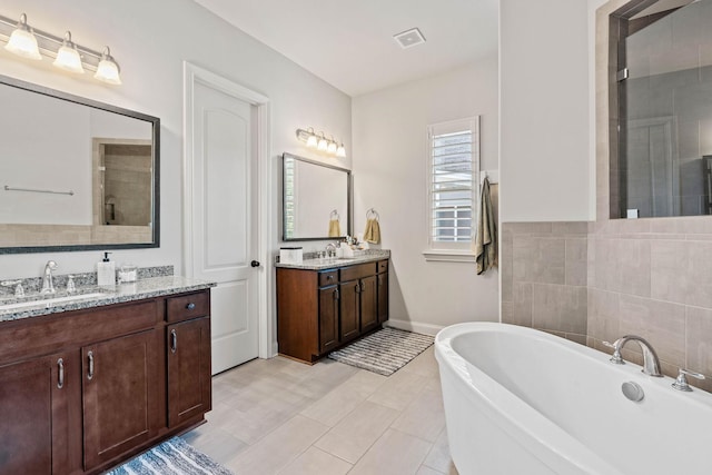 1210 Proprietors Pl, Murfreesboro, TN 37128 - bathroom featuring a freestanding tub, two vanities, and baseboards