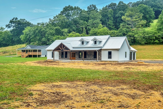 53 Kemp Hollow Rd, Pleasant Shade, TN 37145 - view of front of house featuring covered porch, a front lawn, a metal roof, and a garage