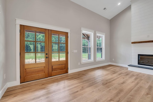 53 Kemp Hollow Rd, Pleasant Shade, TN 37145 - doorway to outside with french doors, light wood-type flooring, a large fireplace, and high vaulted ceiling