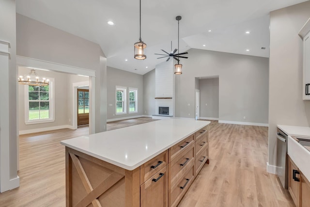 53 Kemp Hollow Rd, Pleasant Shade, TN 37145 - kitchen with a fireplace, open floor plan, light wood-style flooring, a ceiling fan, and high vaulted ceiling