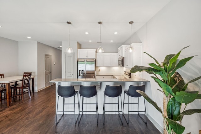 2342 N Tennessee Blvd Unit 1203, Murfreesboro, TN 37130 - kitchen with stainless steel appliances, a peninsula, dark wood finished floors, white cabinets, and a breakfast bar