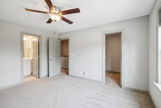 2342 N Tennessee Blvd Unit 1203, Murfreesboro, TN 37130 - unfurnished bedroom with light colored carpet, a walk in closet, baseboards, ensuite bath, and a ceiling fan
