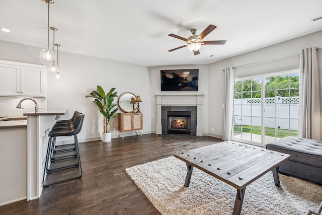 2342 N Tennessee Blvd Unit 1203, Murfreesboro, TN 37130 - living area with a ceiling fan, dark wood finished floors, a tile fireplace, and baseboards