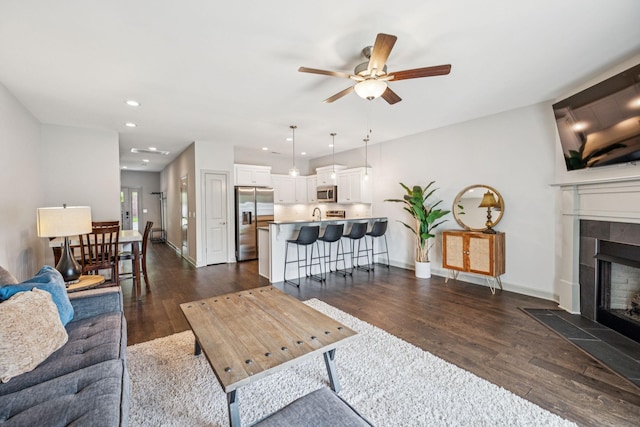 2342 N Tennessee Blvd Unit 1203, Murfreesboro, TN 37130 - living room featuring a ceiling fan, dark wood-style floors, a tiled fireplace, recessed lighting, and baseboards