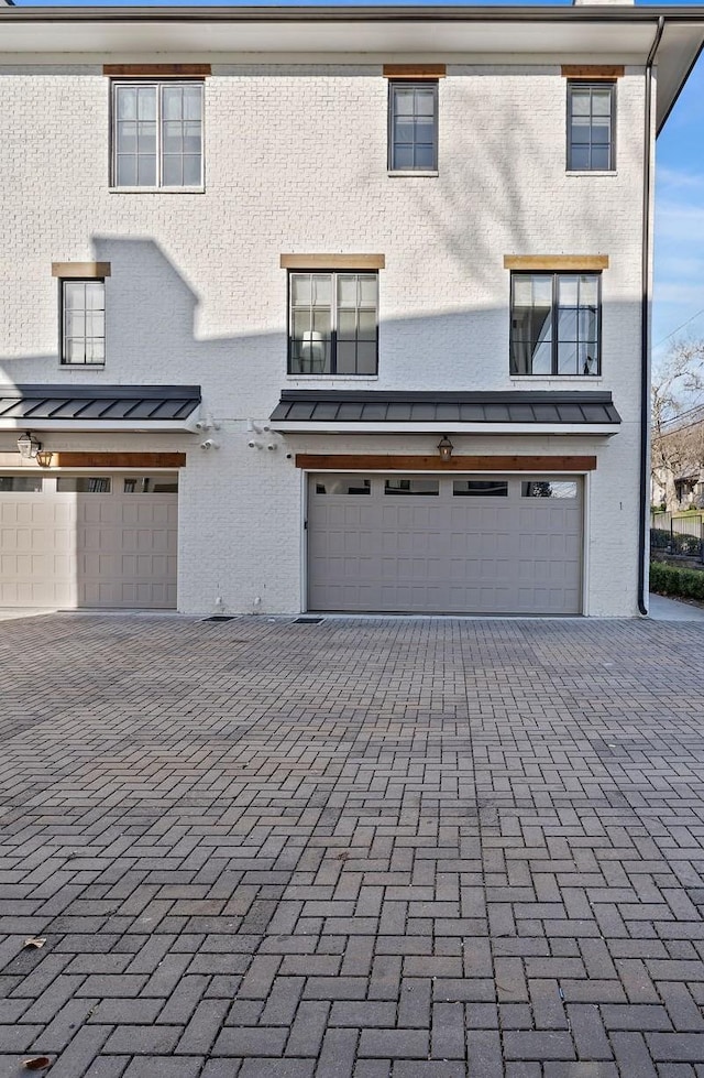 519 Chesterfield Ave Unit 1, Nashville, TN 37212 - multi unit property featuring a standing seam roof, an attached garage, decorative driveway, and metal roof