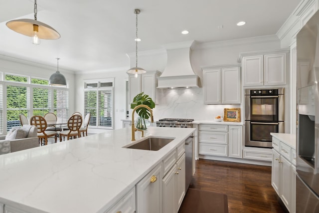 4620 Nadine Ln, Franklin, TN 37064 - kitchen featuring stainless steel appliances, a sink, premium range hood, dark wood-style floors, and hanging light fixtures