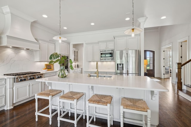 4620 Nadine Ln, Franklin, TN 37064 - kitchen featuring appliances with stainless steel finishes, wall chimney range hood, a sink, light countertops, and recessed lighting