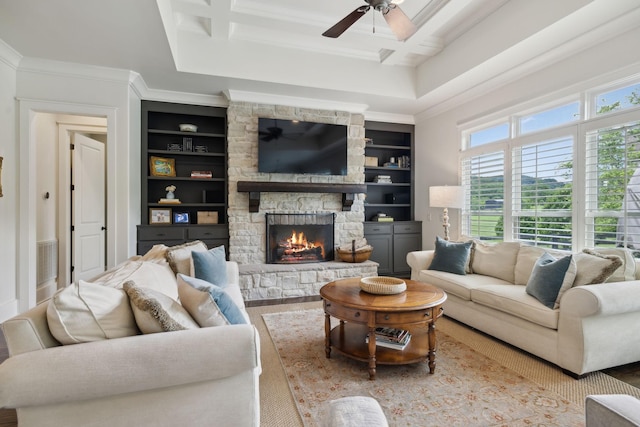 4620 Nadine Ln, Franklin, TN 37064 - living room featuring a ceiling fan, a stone fireplace, built in shelves, crown molding, and coffered ceiling