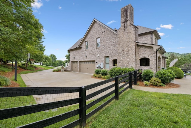 4620 Nadine Ln, Franklin, TN 37064 - view of side of property with an attached garage, brick siding, concrete driveway, and a chimney