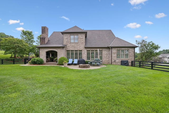 4620 Nadine Ln, Franklin, TN 37064 - rear view of house with a chimney, brick siding, a patio area, and an outdoor fire pit