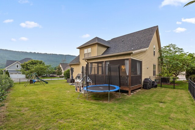 808 Willcrest Dr, Chattanooga, TN 37405 - rear view of property with a sunroom, a trampoline, a playground, and roof with shingles