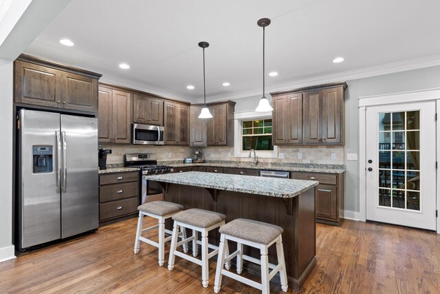 808 Willcrest Dr, Chattanooga, TN 37405 - kitchen featuring appliances with stainless steel finishes, ornamental molding, dark brown cabinetry, tasteful backsplash, and recessed lighting