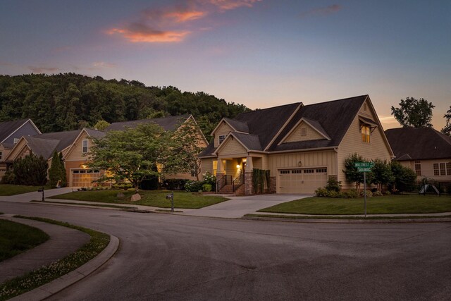 808 Willcrest Dr, Chattanooga, TN 37405 - craftsman house with concrete driveway, board and batten siding, a front lawn, and stone siding