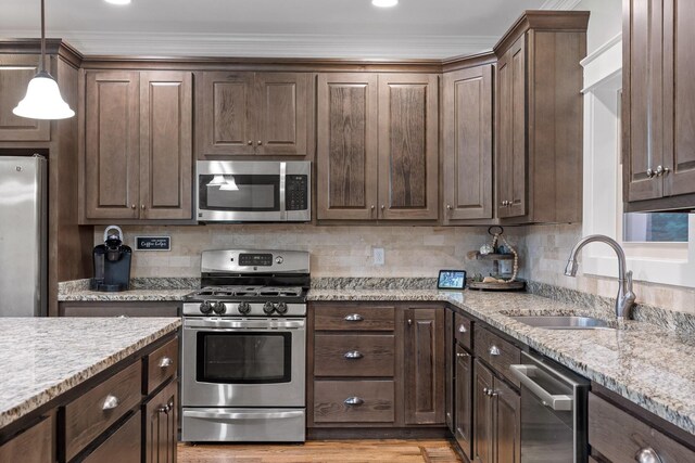 808 Willcrest Dr, Chattanooga, TN 37405 - kitchen featuring stainless steel appliances, a sink, dark brown cabinetry, ornamental molding, and recessed lighting
