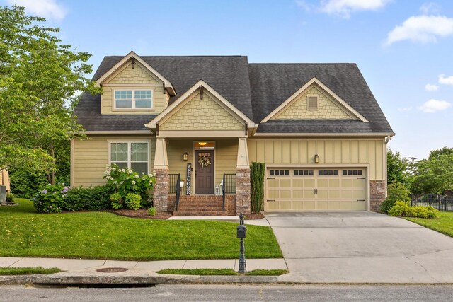 808 Willcrest Dr, Chattanooga, TN 37405 - craftsman-style home featuring a front yard, a garage, concrete driveway, board and batten siding, and stone siding