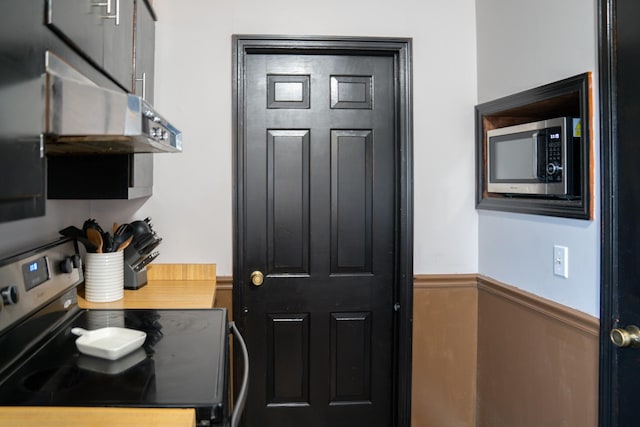 4169 Bledsoe St, Westmoreland, TN 37186 - kitchen with stainless steel appliances, under cabinet range hood, and wainscoting