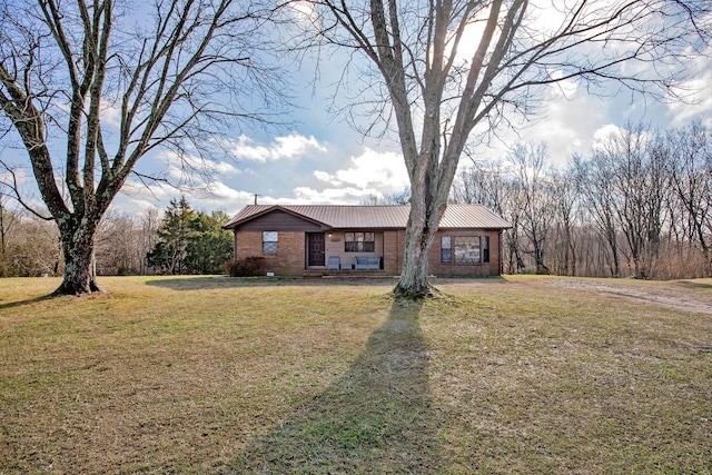 4169 Bledsoe St, Westmoreland, TN 37186 - ranch-style home with brick siding, metal roof, and a front lawn