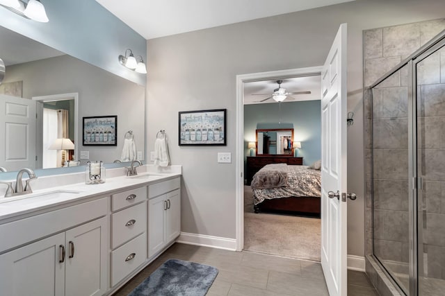 566 Oakvale Ln, Mount Juliet, TN 37122 - ensuite bathroom with baseboards, double vanity, a stall shower, ceiling fan, and tile patterned flooring