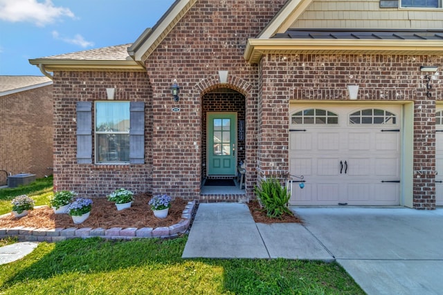 566 Oakvale Ln, Mount Juliet, TN 37122 - doorway to property featuring brick siding, concrete driveway, an attached garage, and central AC unit