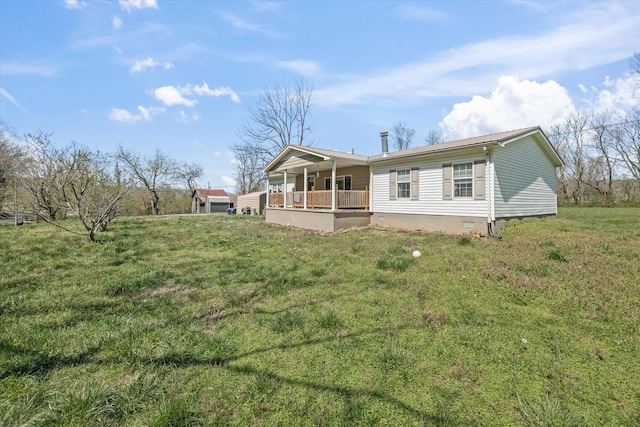 125 Fitzgerald Ave, Celina, TN 38551 - back of property with a lawn, covered porch, and crawl space