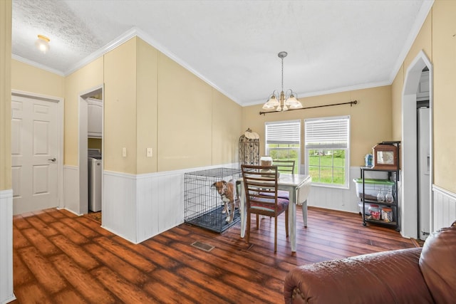 125 Fitzgerald Ave, Celina, TN 38551 - dining space featuring wood finished floors, a chandelier, wainscoting, crown molding, and washer / clothes dryer