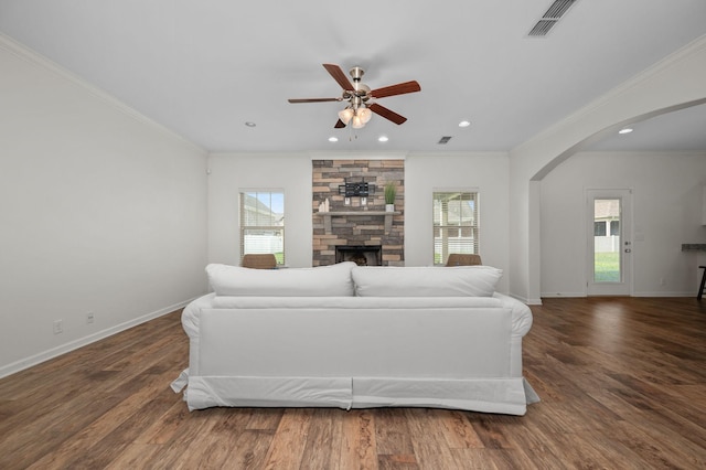 1113 Dunkirk Ln, Murfreesboro, TN 37129 - living area featuring arched walkways, healthy amount of natural light, ceiling fan, a fireplace, and crown molding