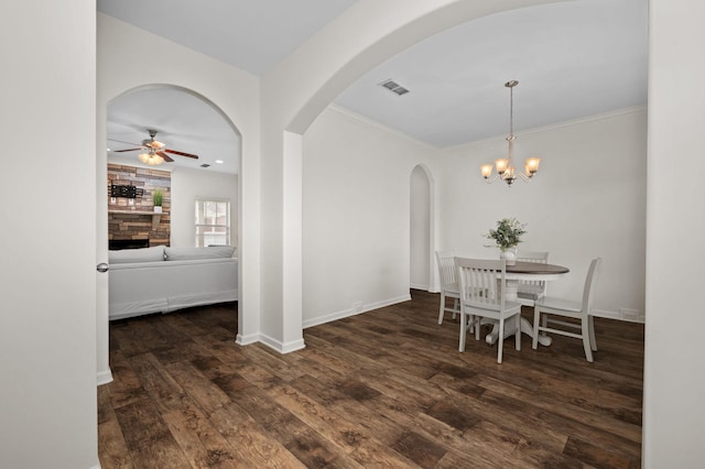 1113 Dunkirk Ln, Murfreesboro, TN 37129 - dining room with arched walkways, wood finished floors, ceiling fan, a fireplace, and crown molding