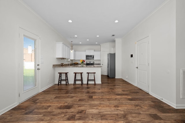 1113 Dunkirk Ln, Murfreesboro, TN 37129 - kitchen with appliances with stainless steel finishes, a peninsula, dark wood-type flooring, white cabinetry, and ornamental molding