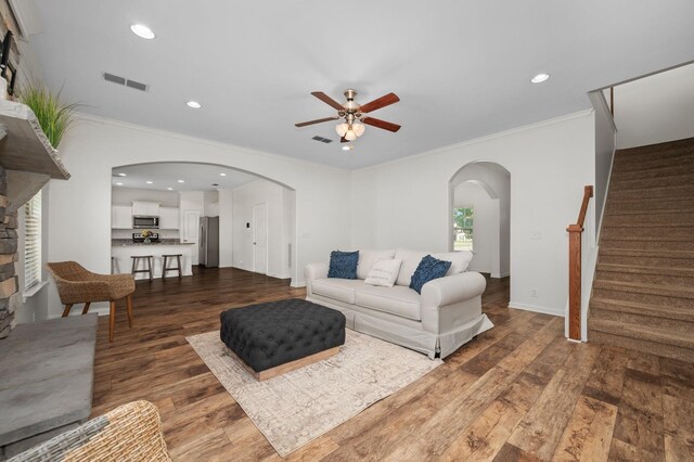 1113 Dunkirk Ln, Murfreesboro, TN 37129 - living area with arched walkways, ceiling fan, dark wood-type flooring, crown molding, and stairway