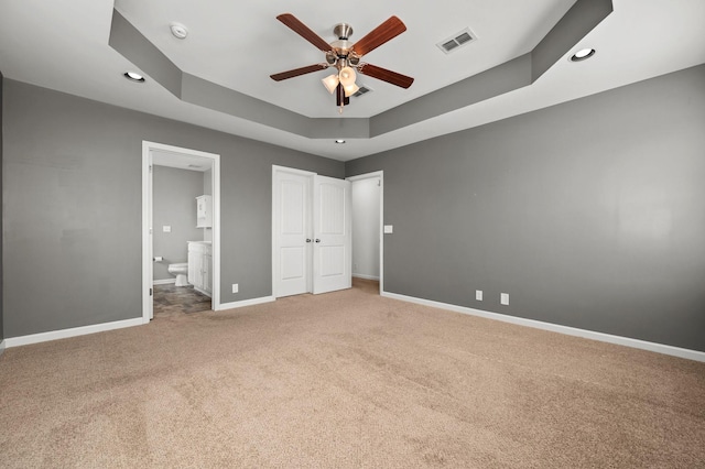 1113 Dunkirk Ln, Murfreesboro, TN 37129 - unfurnished bedroom featuring carpet floors, a tray ceiling, baseboards, connected bathroom, and recessed lighting