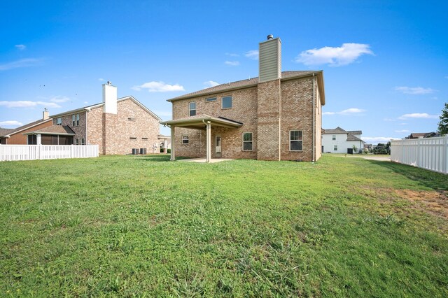1113 Dunkirk Ln, Murfreesboro, TN 37129 - back of property featuring brick siding, a patio area, a chimney, and central AC