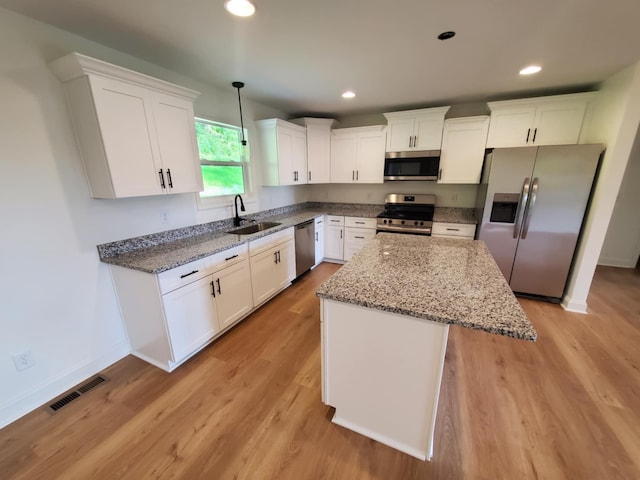 321 Turkey Creek Hwy, Carthage, TN 37030 - kitchen with stainless steel appliances, a sink, white cabinets, baseboards, and light stone countertops