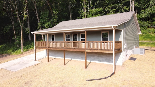 321 Turkey Creek Hwy, Carthage, TN 37030 - view of front of home featuring cooling unit, a wooded view, and covered porch