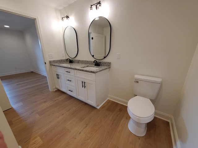 321 Turkey Creek Hwy, Carthage, TN 37030 - bathroom with baseboards, wood finished floors, double vanity, and toilet