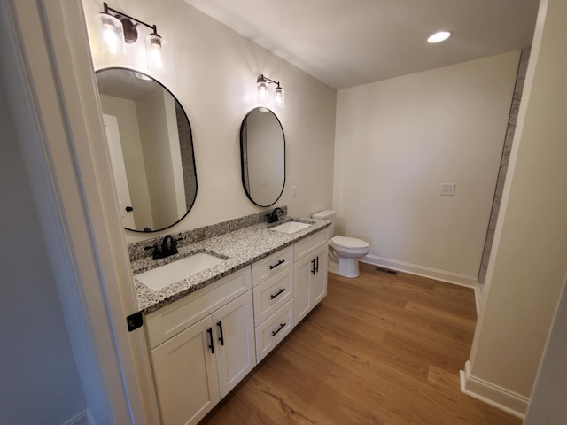 321 Turkey Creek Hwy, Carthage, TN 37030 - full bathroom featuring double vanity, wood finished floors, toilet, and baseboards