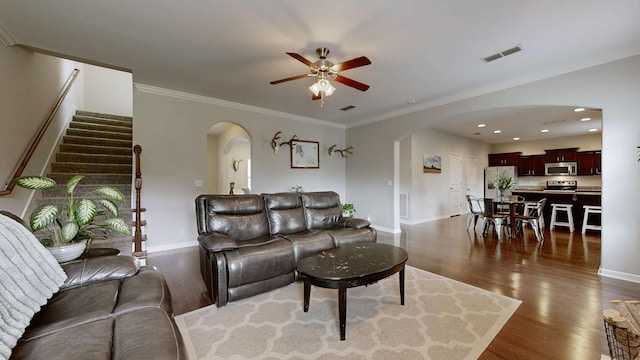 5127 Heroes Ln, Murfreesboro, TN 37129 - living room with arched walkways, ceiling fan, dark wood-type flooring, stairs, and baseboards