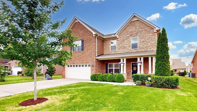 5127 Heroes Ln, Murfreesboro, TN 37129 - traditional home featuring driveway, a front yard, a garage, covered porch, and brick siding