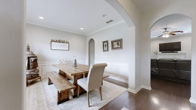 5127 Heroes Ln, Murfreesboro, TN 37129 - dining area featuring arched walkways, crown molding, a ceiling fan, a wainscoted wall, and hardwood / wood-style flooring