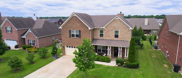 5127 Heroes Ln, Murfreesboro, TN 37129 - traditional-style house with a garage, covered porch, driveway, a front lawn, and a residential view